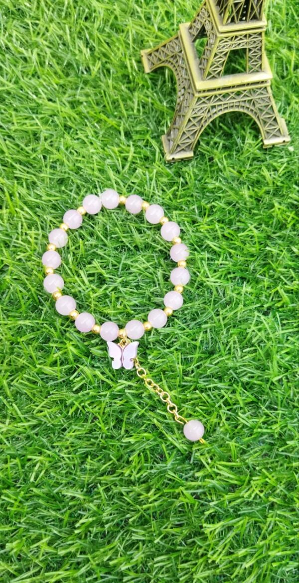 Purple beaded bracelet with butterfly charm